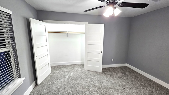 unfurnished bedroom featuring carpet, ceiling fan, and a closet