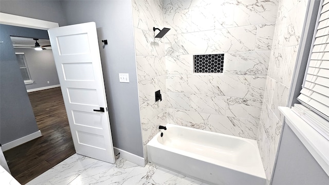 bathroom with tiled shower / bath, hardwood / wood-style floors, and ceiling fan