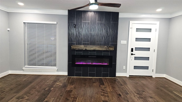 4526 Dixie Dr, Houston, TX 77021 - entryway featuring crown molding, wood finished floors, a ceiling fan, a glass covered fireplace, and baseboards