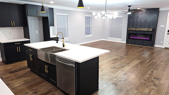 4526 Dixie Dr, Houston, TX 77021 - kitchen featuring dishwasher, dark cabinets, a sink, a large fireplace, and open floor plan