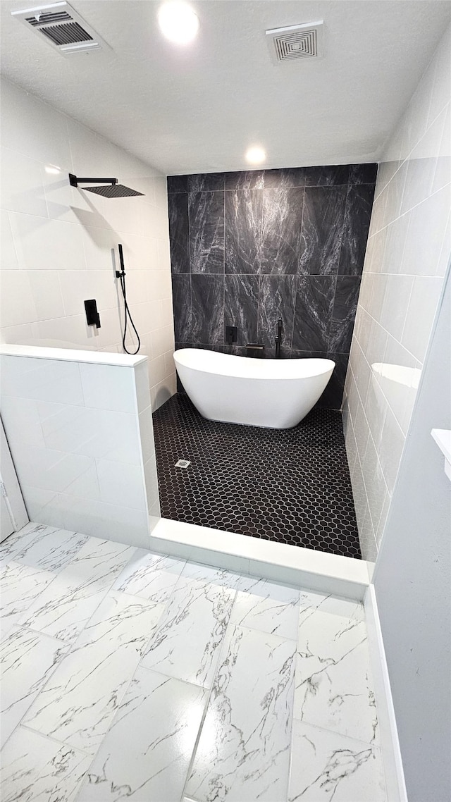 bathroom featuring separate shower and tub and tile walls