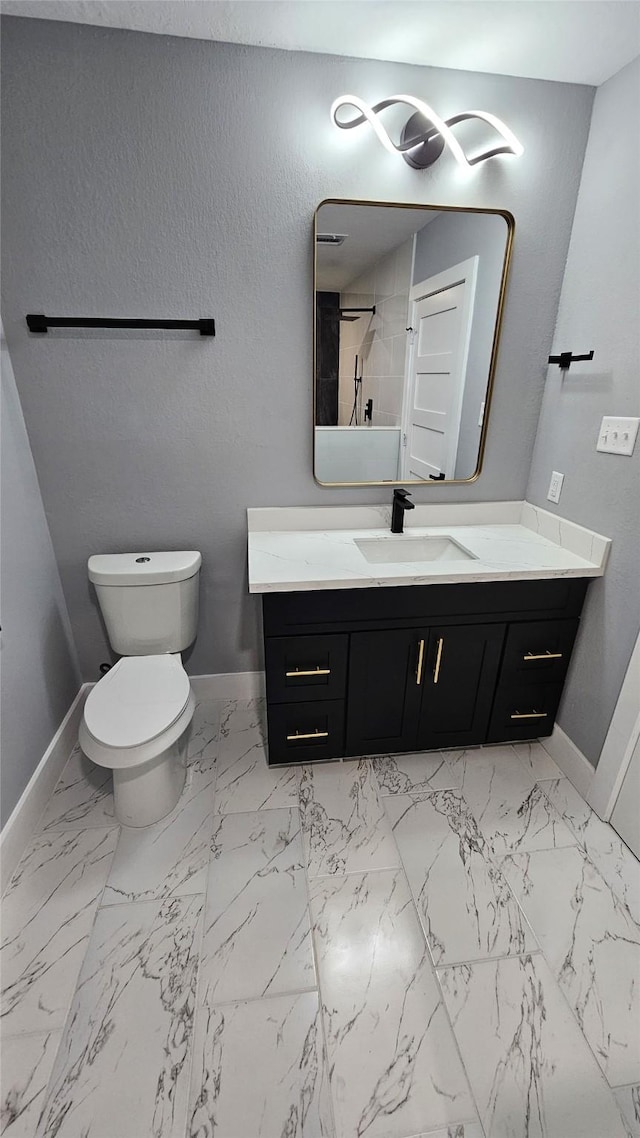 4526 Dixie Dr, Houston, TX 77021 - bathroom with baseboards, toilet, vanity, and marble look tiles