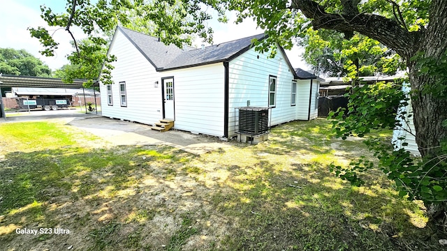 view of property exterior with a lawn, central air condition unit, and a patio area