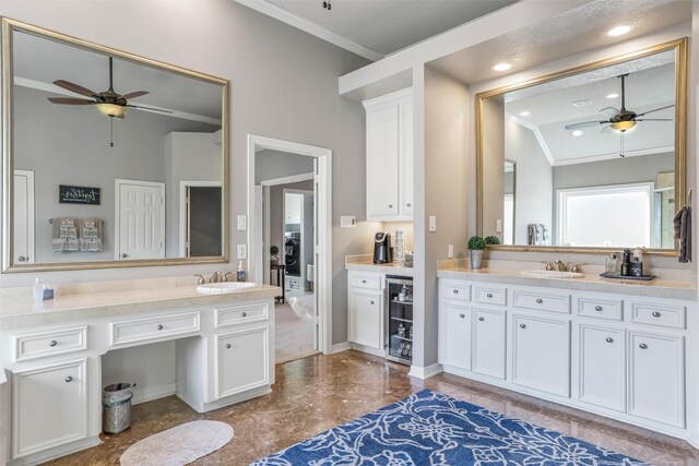 bathroom featuring washer / clothes dryer, crown molding, vanity, and lofted ceiling