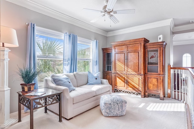 sitting room featuring ceiling fan, light colored carpet, and ornamental molding