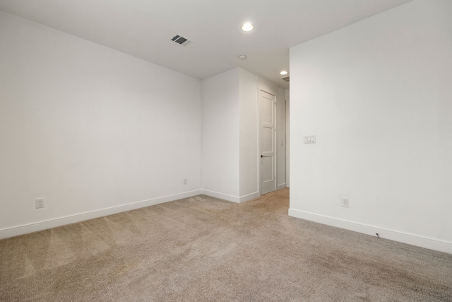 unfurnished room featuring light colored carpet