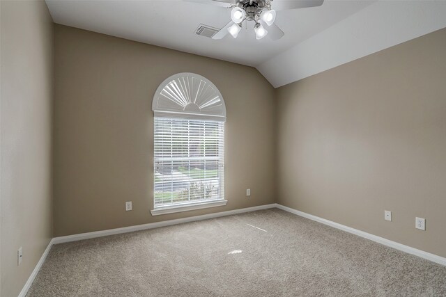 carpeted empty room with ceiling fan and vaulted ceiling