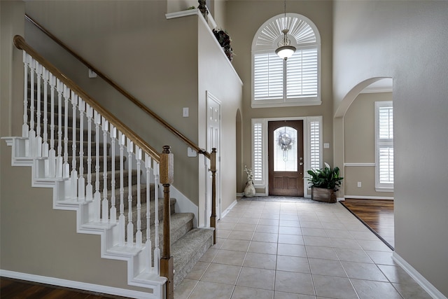 entrance foyer with a high ceiling and light wood-type flooring