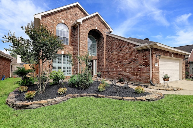 view of property featuring a garage and a front lawn