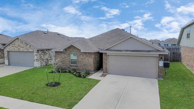 view of front of house featuring central AC, a front yard, and a garage