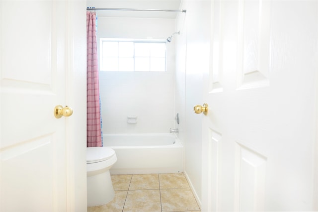 bathroom with tile patterned flooring, toilet, and shower / tub combo with curtain