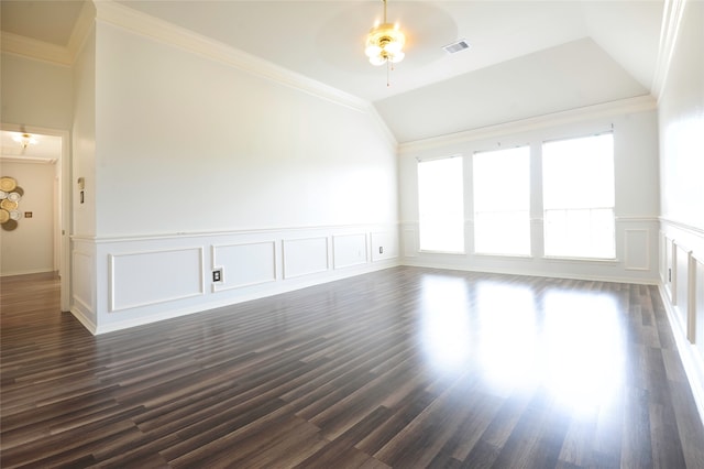 empty room with lofted ceiling, dark hardwood / wood-style floors, and crown molding