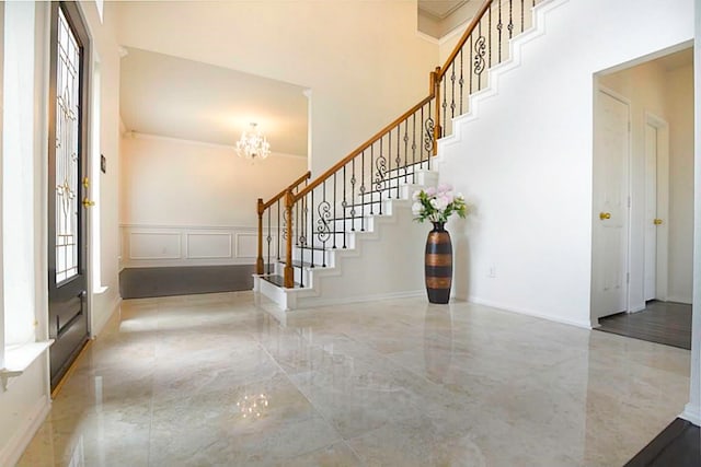 foyer featuring a notable chandelier and a towering ceiling