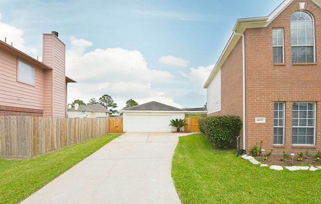 view of side of property with a garage and a lawn