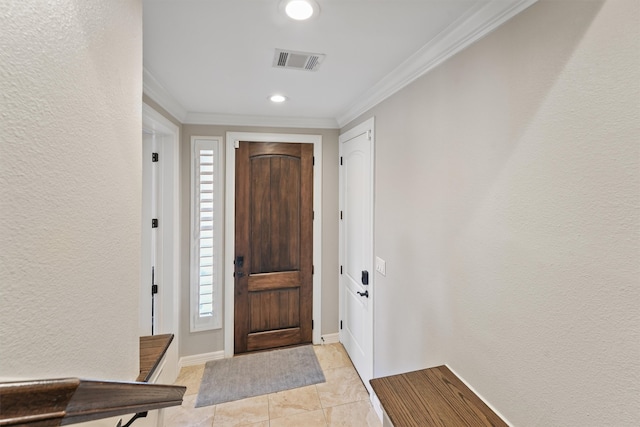 tiled entrance foyer featuring crown molding