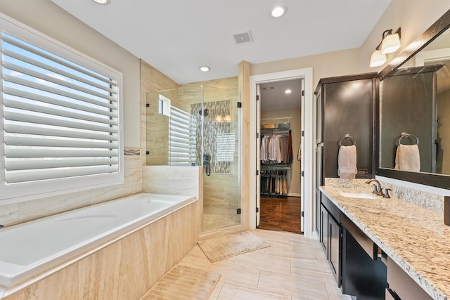 bathroom with tile patterned flooring, vanity, and independent shower and bath