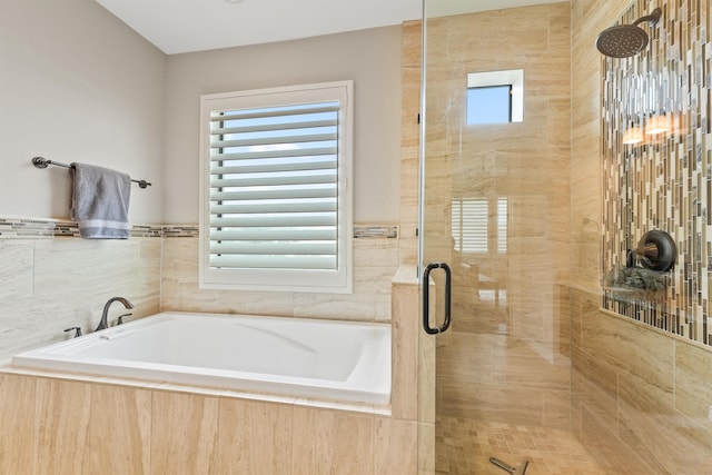 bathroom with a wealth of natural light, plus walk in shower, and tile walls