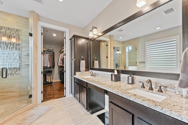 bathroom featuring wood-type flooring, vanity, and an enclosed shower