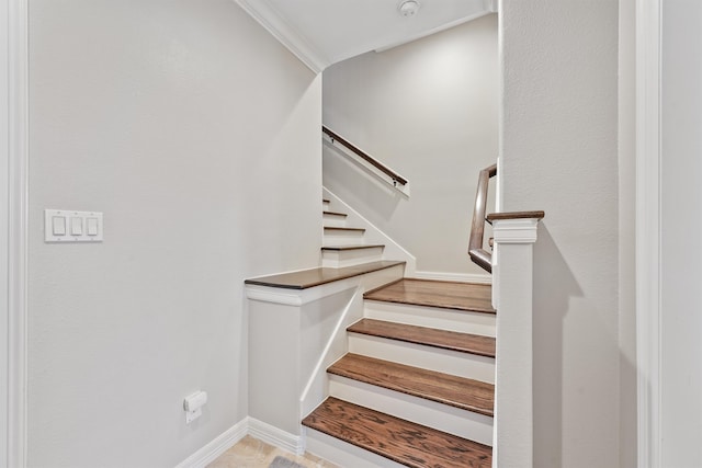 staircase featuring ornamental molding