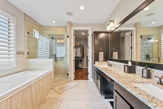 bathroom featuring tile patterned flooring, vanity, a healthy amount of sunlight, and separate shower and tub