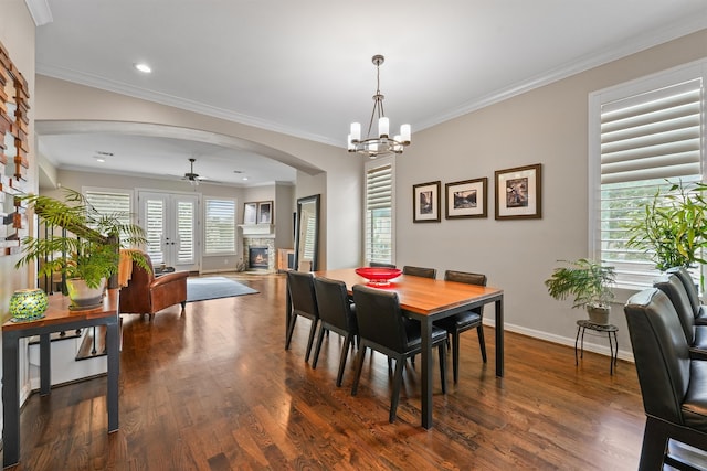 dining room with ceiling fan with notable chandelier, dark hardwood / wood-style flooring, and ornamental molding