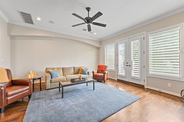 living room with french doors, hardwood / wood-style floors, ornamental molding, and ceiling fan