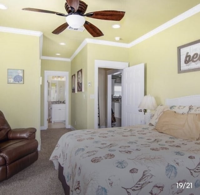 carpeted bedroom with ornamental molding, ceiling fan, and ensuite bathroom