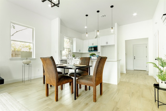 dining space with light hardwood / wood-style floors