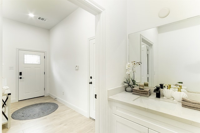 foyer with sink and light hardwood / wood-style flooring