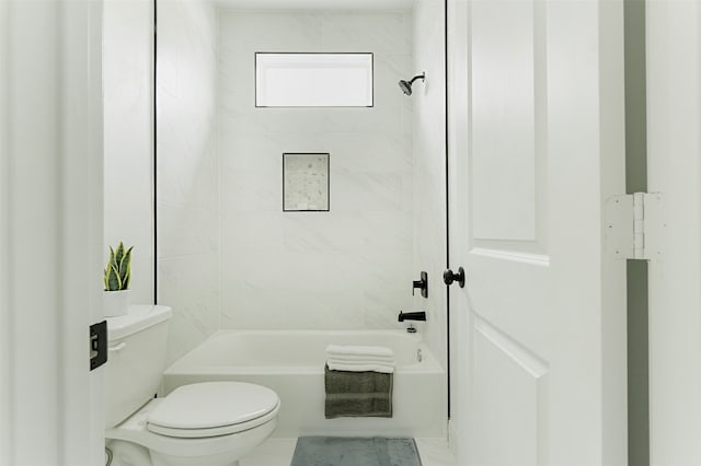 bathroom featuring toilet and tiled shower / bath combo