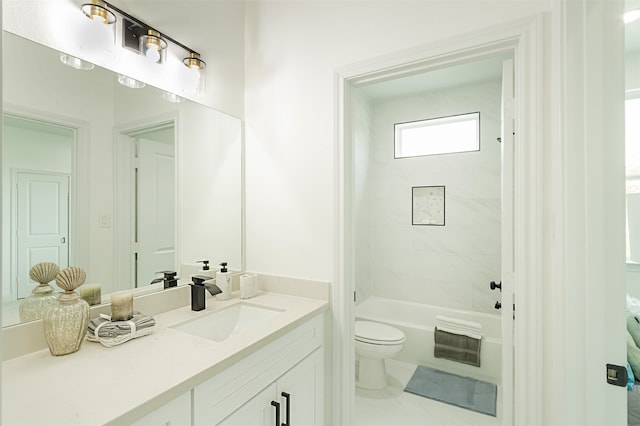 full bathroom with vanity, tiled shower / bath combo, and toilet