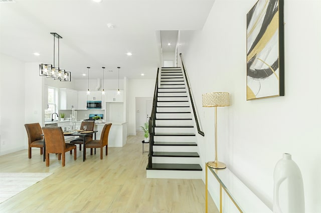 dining area featuring sink and light hardwood / wood-style flooring