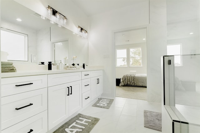 bathroom featuring vanity and a shower with door