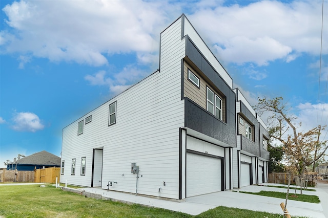 view of property exterior featuring a garage and a yard