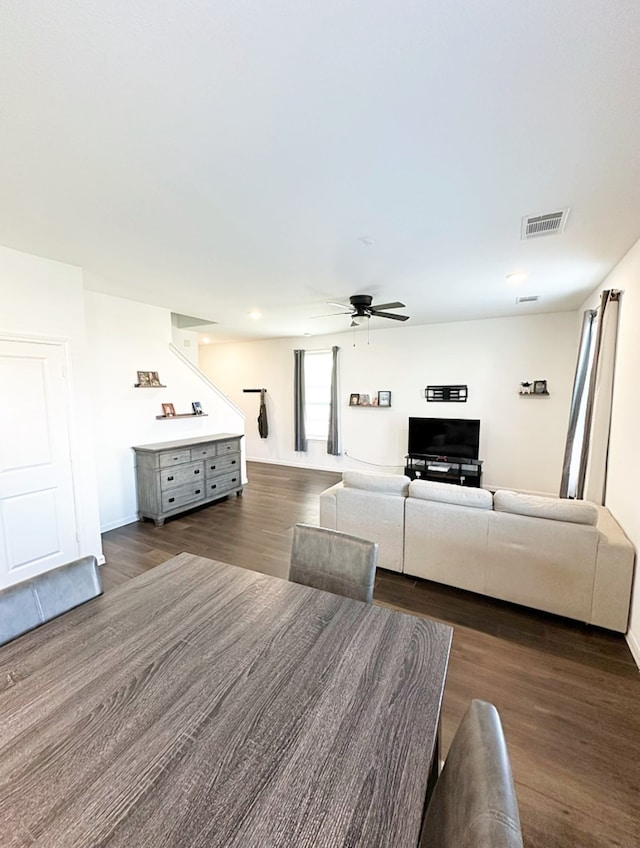 unfurnished living room featuring ceiling fan and dark hardwood / wood-style floors