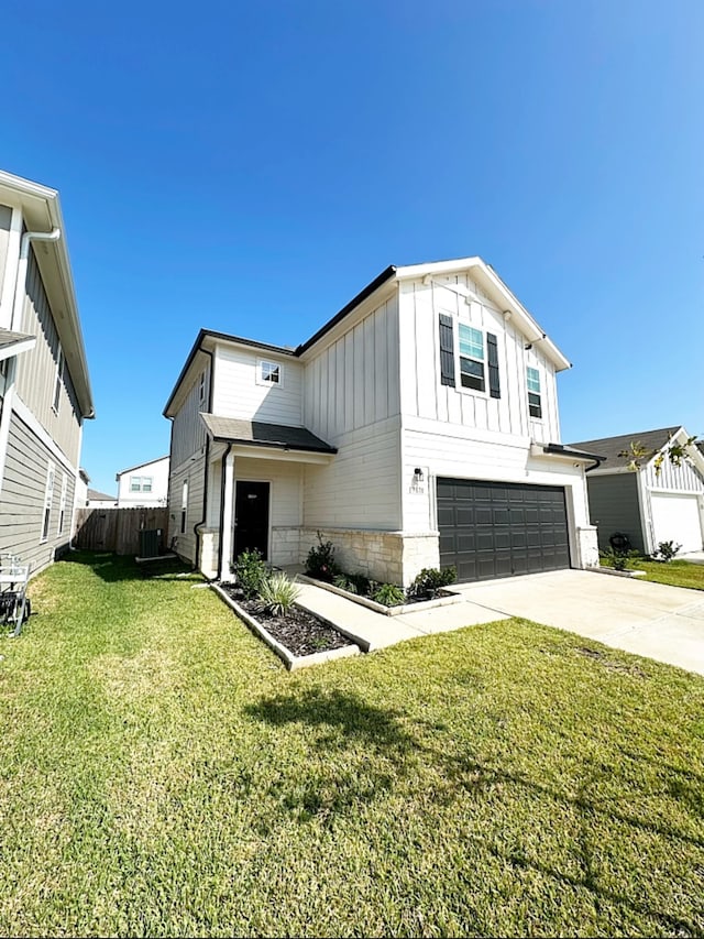 view of front of home with a garage and a front lawn