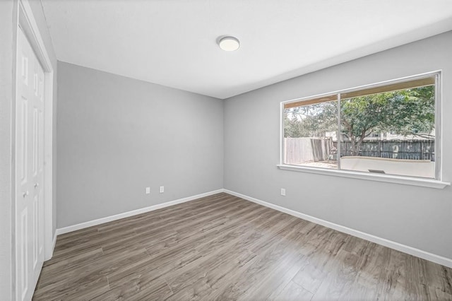 unfurnished bedroom featuring hardwood / wood-style flooring and a closet