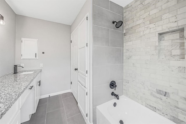 bathroom featuring tile patterned flooring, vanity, and tiled shower / bath combo