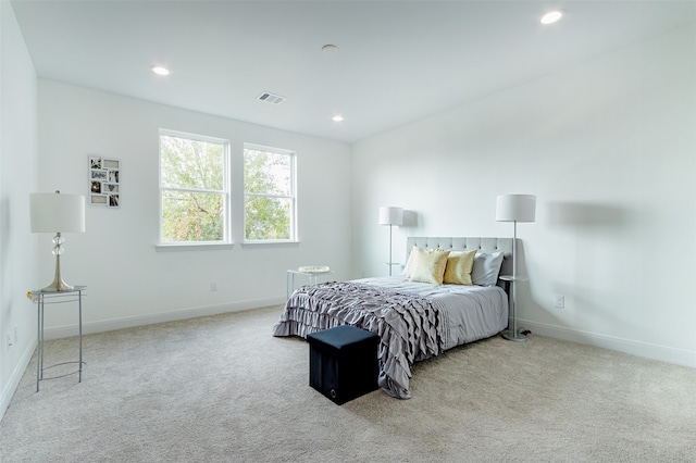 bedroom featuring light colored carpet