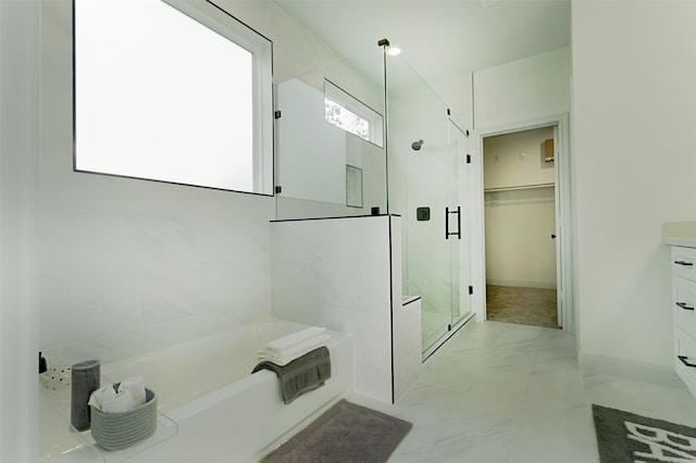 bathroom with vanity and separate shower and tub