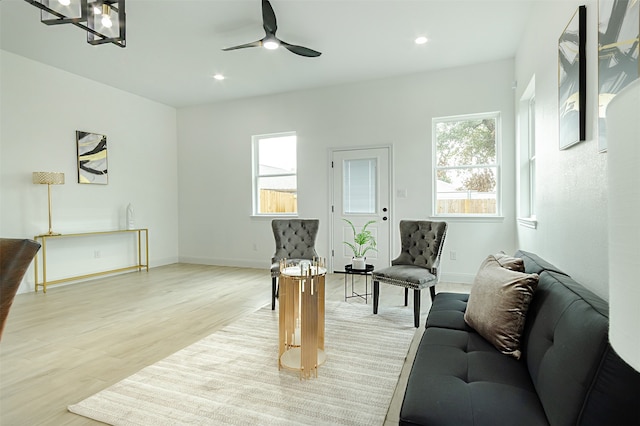 living room featuring ceiling fan and light hardwood / wood-style flooring