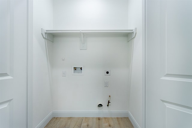 laundry area with gas dryer hookup, hardwood / wood-style flooring, hookup for an electric dryer, and washer hookup