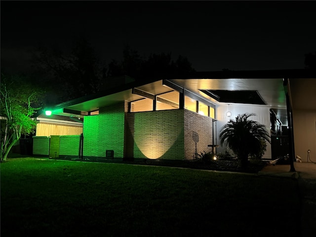 property exterior at twilight with a yard