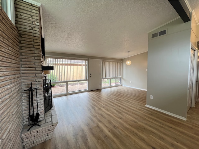 unfurnished living room with hardwood / wood-style floors and a textured ceiling