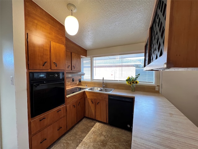 kitchen featuring lofted ceiling, black appliances, a textured ceiling, sink, and decorative light fixtures