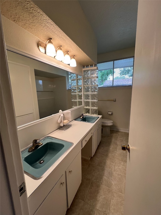 bathroom with vanity, tile patterned floors, a textured ceiling, and toilet