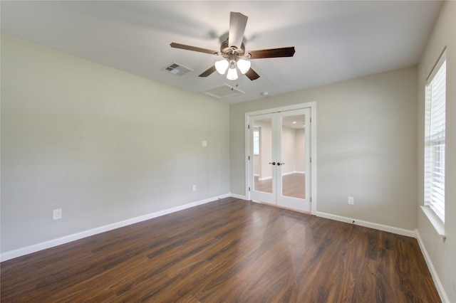 spare room featuring french doors, dark wood-type flooring, and ceiling fan