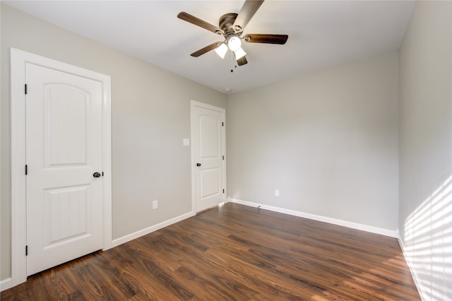 unfurnished room featuring ceiling fan and dark hardwood / wood-style floors