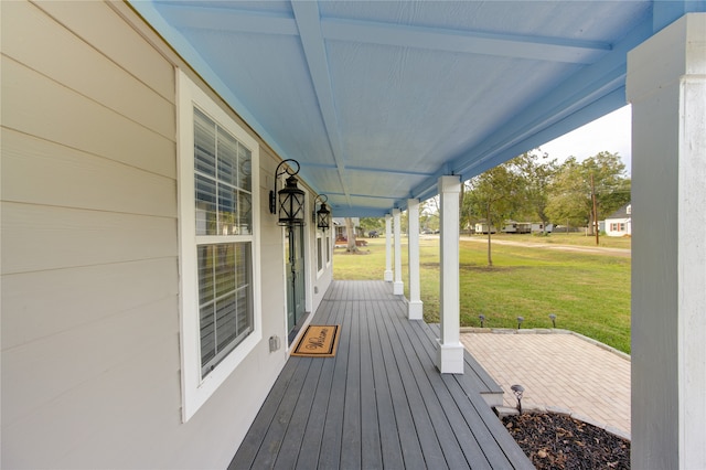 deck with a lawn and covered porch