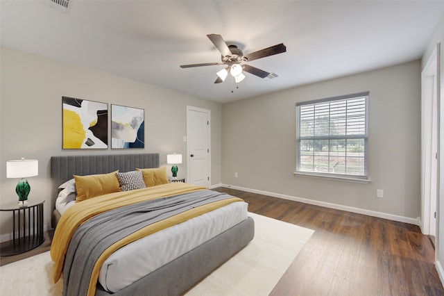 bedroom with dark hardwood / wood-style floors and ceiling fan